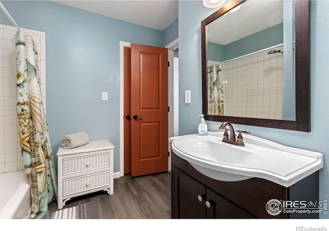 full bath featuring wood finished floors, vanity, and shower / bath combination with curtain