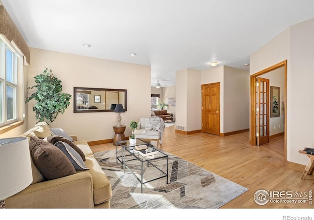 living room featuring light wood finished floors and baseboards