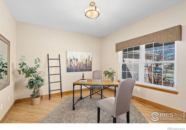 office space featuring baseboards and wood finished floors