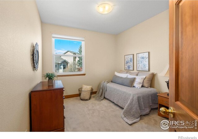 carpeted bedroom featuring baseboards