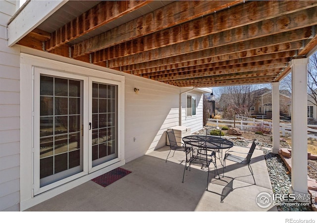 view of patio / terrace featuring outdoor dining area and fence