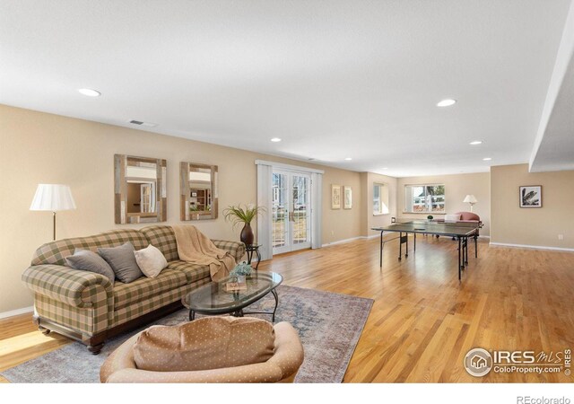 living area featuring visible vents, recessed lighting, french doors, and light wood-type flooring