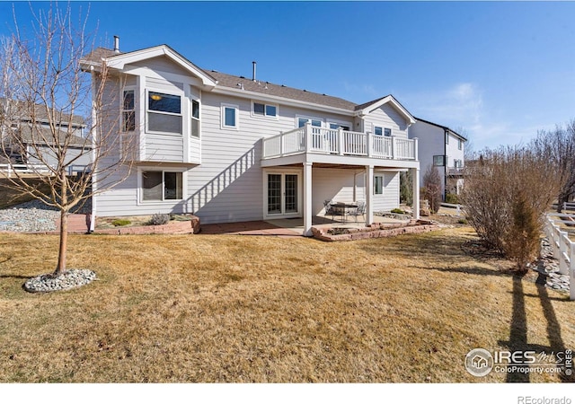 back of property featuring a patio, a yard, and a wooden deck