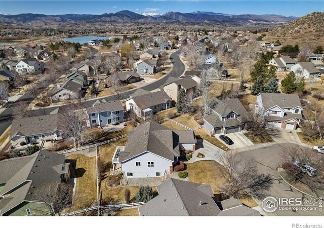 drone / aerial view with a residential view and a water and mountain view