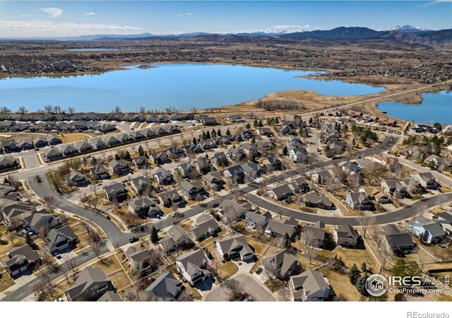 aerial view featuring a residential view and a water and mountain view