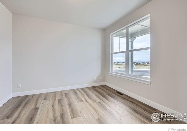 1685 Crystalline Dr, Windsor, CO 80550 - empty room featuring light wood finished floors, visible vents, and baseboards