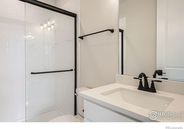 1685 Crystalline Dr, Windsor, CO 80550 - bathroom featuring toilet, tiled shower, and vanity