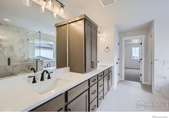 1685 Crystalline Dr, Windsor, CO 80550 - bathroom with a sink, visible vents, double vanity, and a marble finish shower