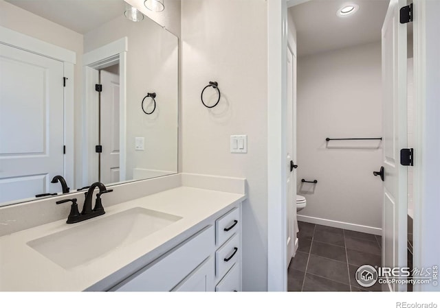 1685 Crystalline Dr, Windsor, CO 80550 - bathroom with vanity, baseboards, recessed lighting, tile patterned floors, and toilet