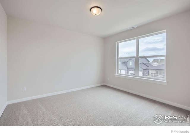 1685 Crystalline Dr, Windsor, CO 80550 - empty room featuring visible vents, baseboards, and light colored carpet