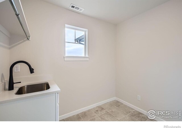 1685 Crystalline Dr, Windsor, CO 80550 - laundry area with a sink, visible vents, and baseboards