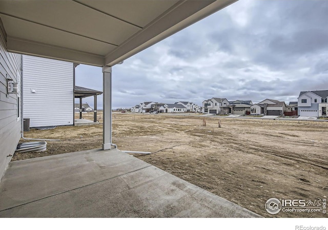1685 Crystalline Dr, Windsor, CO 80550 - view of yard with a residential view, a patio area, and central AC