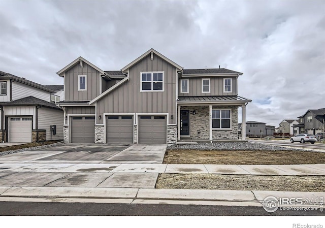 1685 Crystalline Dr, Windsor, CO 80550 - craftsman-style house with concrete driveway, board and batten siding, a garage, and stone siding