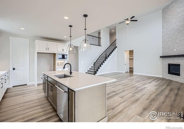 1685 Crystalline Dr, Windsor, CO 80550 - kitchen with a sink, open floor plan, light countertops, appliances with stainless steel finishes, and a ceiling fan