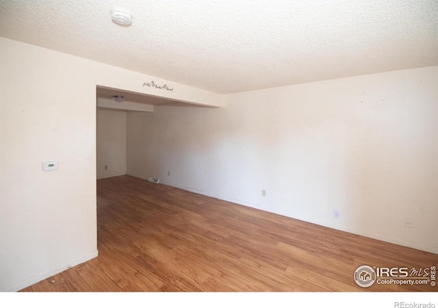 1351 Emery St, Longmont, CO 80501 - spare room featuring a textured ceiling and light wood finished floors