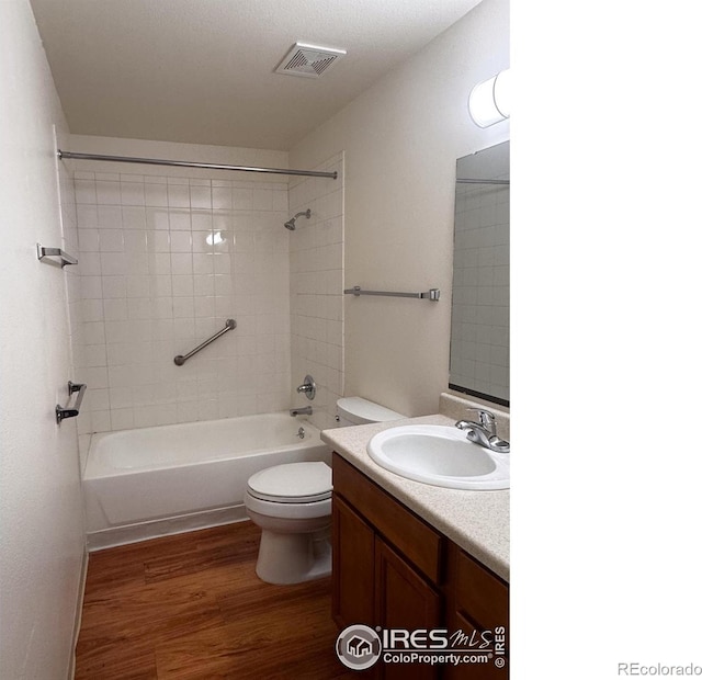 1351 Emery St, Longmont, CO 80501 - bathroom featuring vanity, wood finished floors, visible vents, shower / washtub combination, and toilet