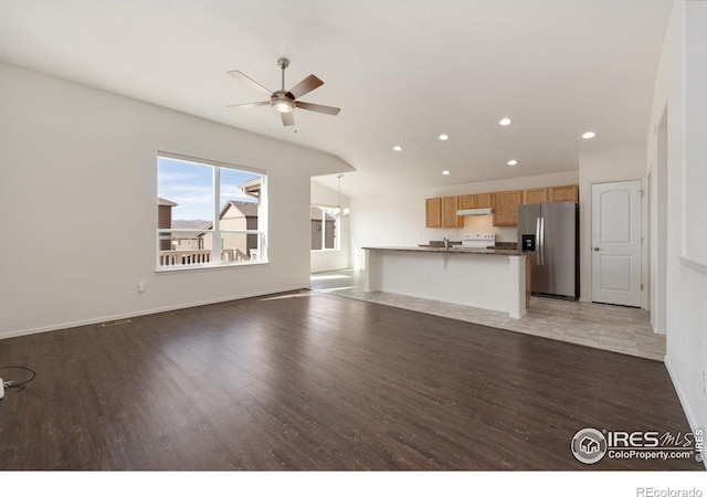 unfurnished living room with light wood finished floors, recessed lighting, baseboards, and ceiling fan