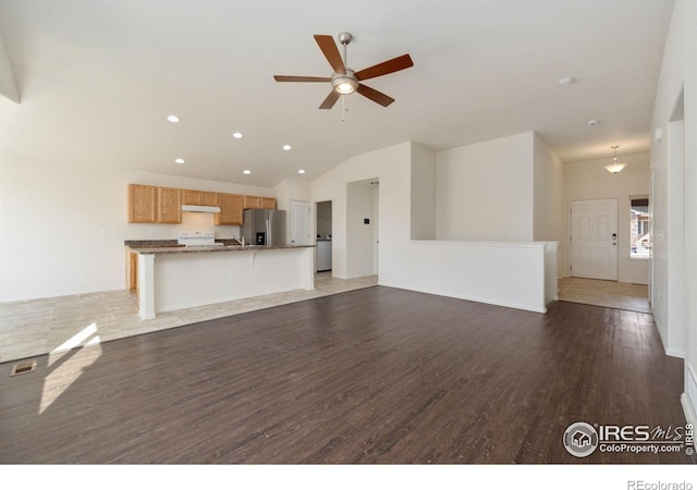 unfurnished living room featuring a ceiling fan, wood finished floors, visible vents, recessed lighting, and vaulted ceiling