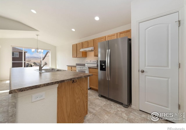 kitchen with dark countertops, under cabinet range hood, stainless steel fridge, white electric range, and a sink