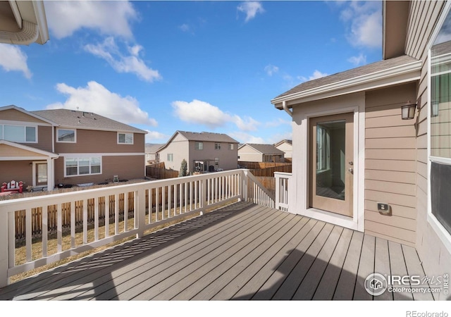 deck with a residential view and fence