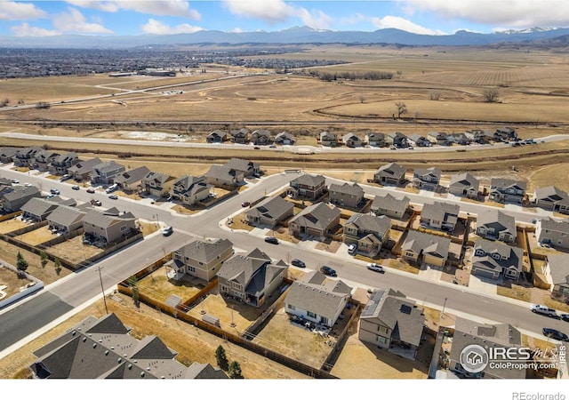 birds eye view of property with a mountain view and a residential view