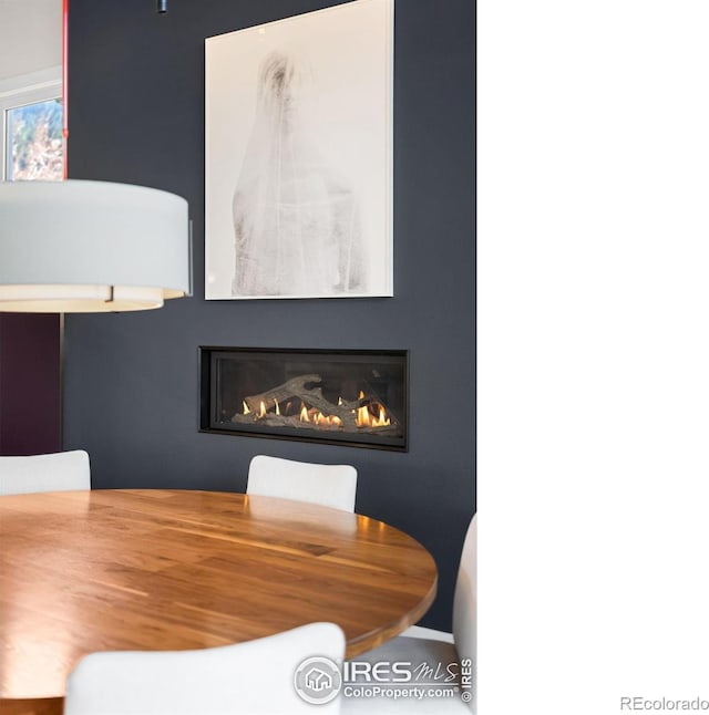 dining area with a glass covered fireplace