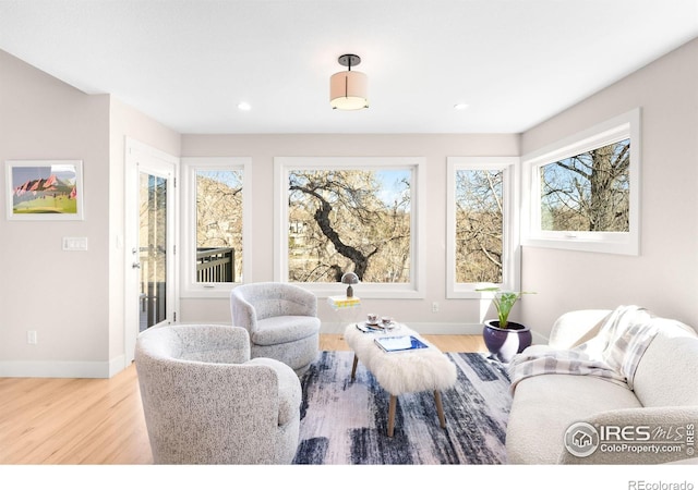 living room featuring recessed lighting, baseboards, and wood finished floors