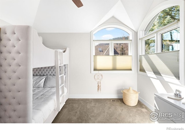 bedroom featuring vaulted ceiling, multiple windows, visible vents, and carpet floors