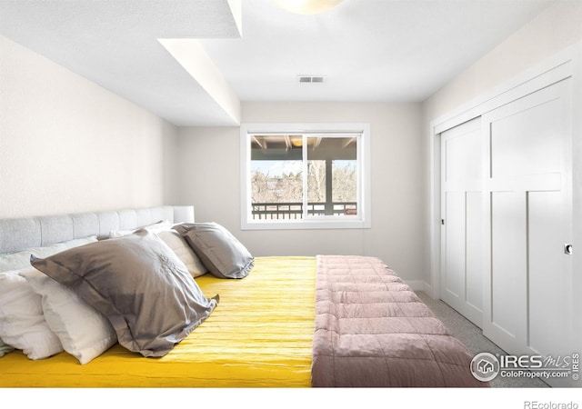 bedroom featuring a closet, visible vents, and carpet floors