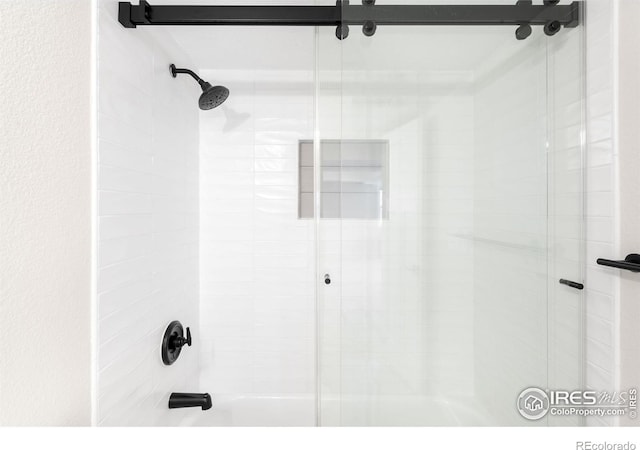 full bathroom featuring combined bath / shower with glass door