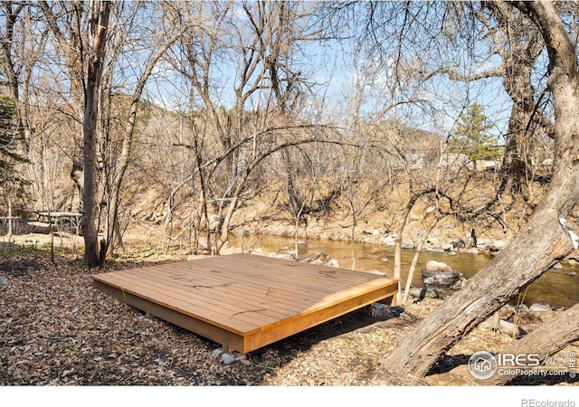 wooden terrace featuring a water view