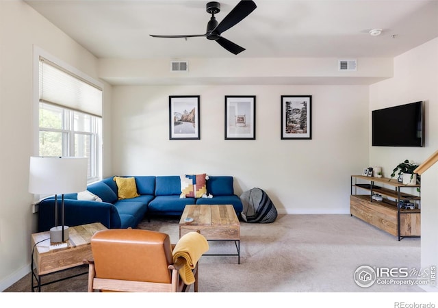 carpeted living area featuring a ceiling fan, baseboards, and visible vents