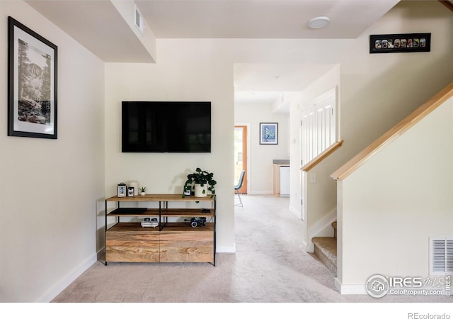 interior space with stairs, baseboards, and visible vents