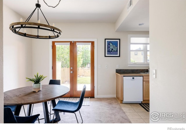 dining room with visible vents, baseboards, a chandelier, light tile patterned floors, and french doors