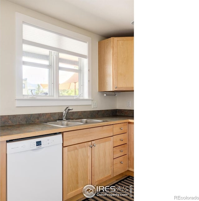 kitchen featuring a sink, dark countertops, dishwasher, and light brown cabinets