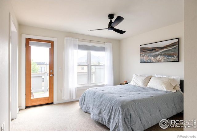 carpeted bedroom with multiple windows and ceiling fan