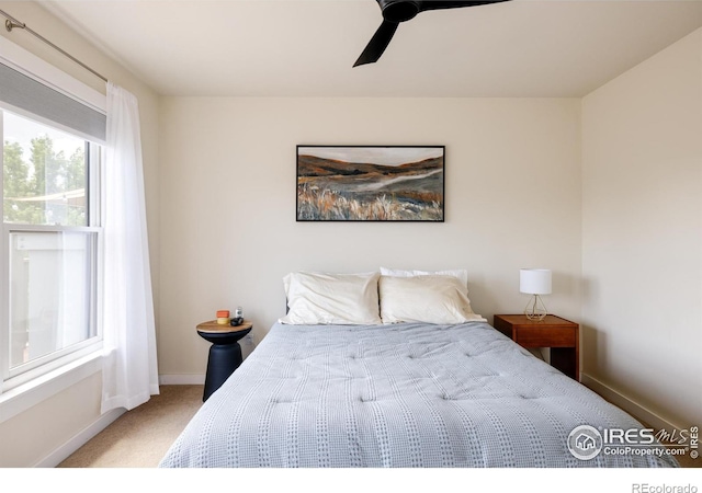 bedroom with baseboards, carpet floors, and ceiling fan