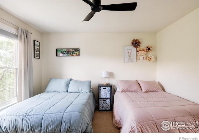 carpeted bedroom featuring ceiling fan