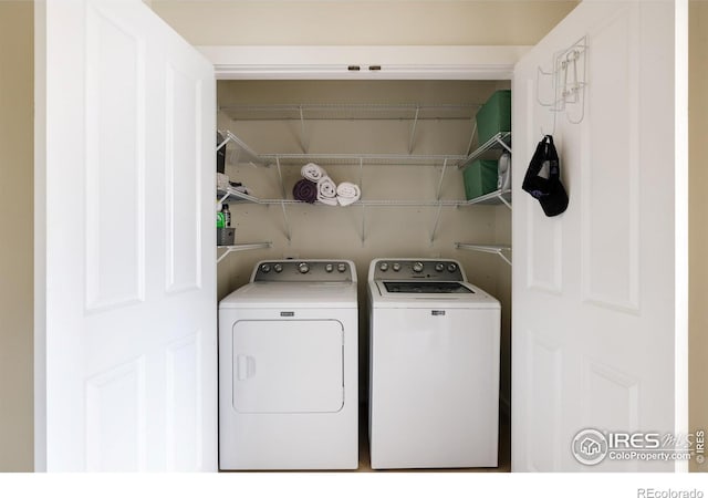 clothes washing area with laundry area and washing machine and clothes dryer