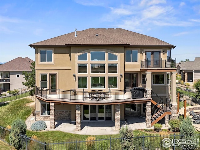 rear view of property featuring stucco siding, a patio, and a fenced backyard