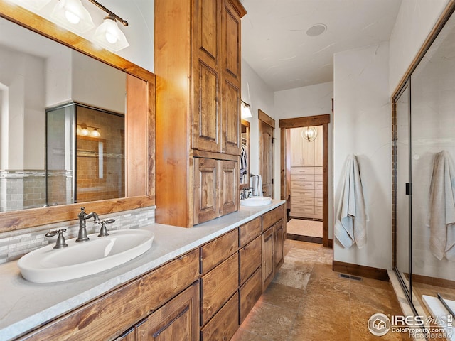 bathroom with decorative backsplash, double vanity, and a sink