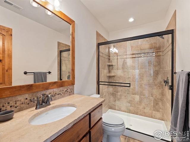 bathroom featuring decorative backsplash, a shower stall, toilet, and visible vents