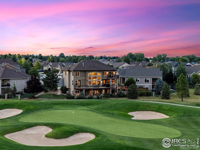 exterior space featuring a residential view, a lawn, and view of golf course