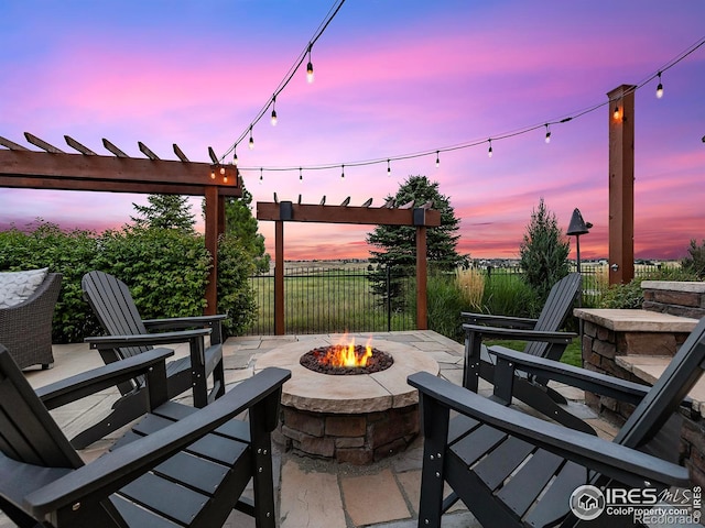 view of patio featuring fence and an outdoor fire pit