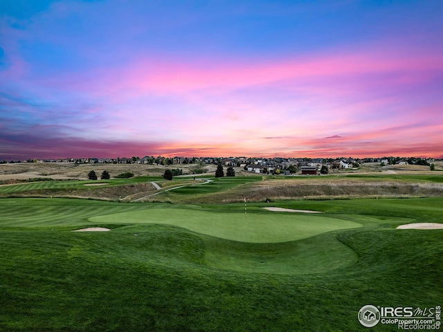 view of home's community with a yard and view of golf course