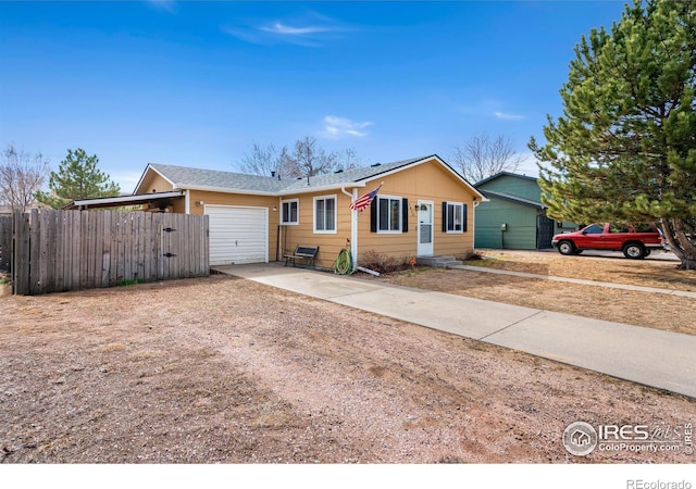 ranch-style house with driveway, a garage, and fence