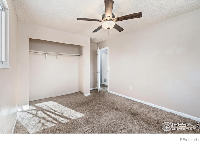 unfurnished bedroom with a ceiling fan, a textured ceiling, a closet, carpet, and baseboards