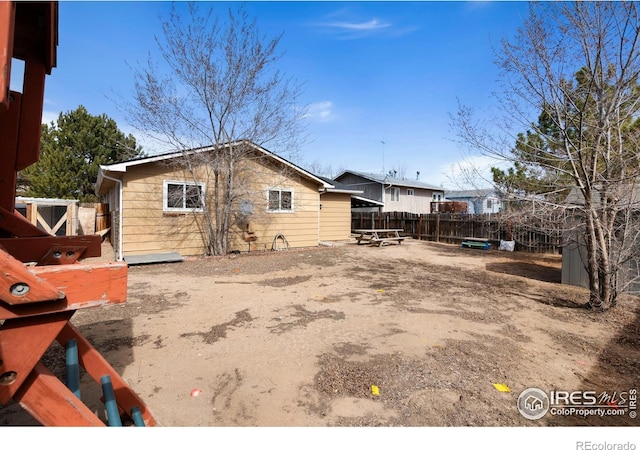 back of house featuring fence