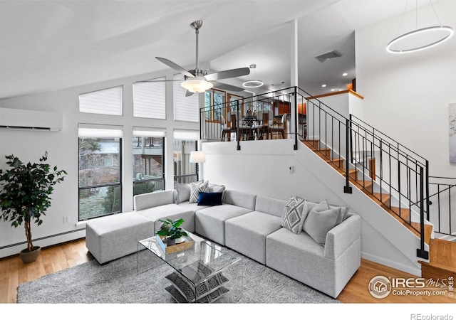 living room featuring visible vents, high vaulted ceiling, wood finished floors, stairway, and baseboard heating