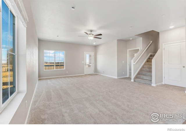 carpeted spare room with stairs, recessed lighting, baseboards, and ceiling fan